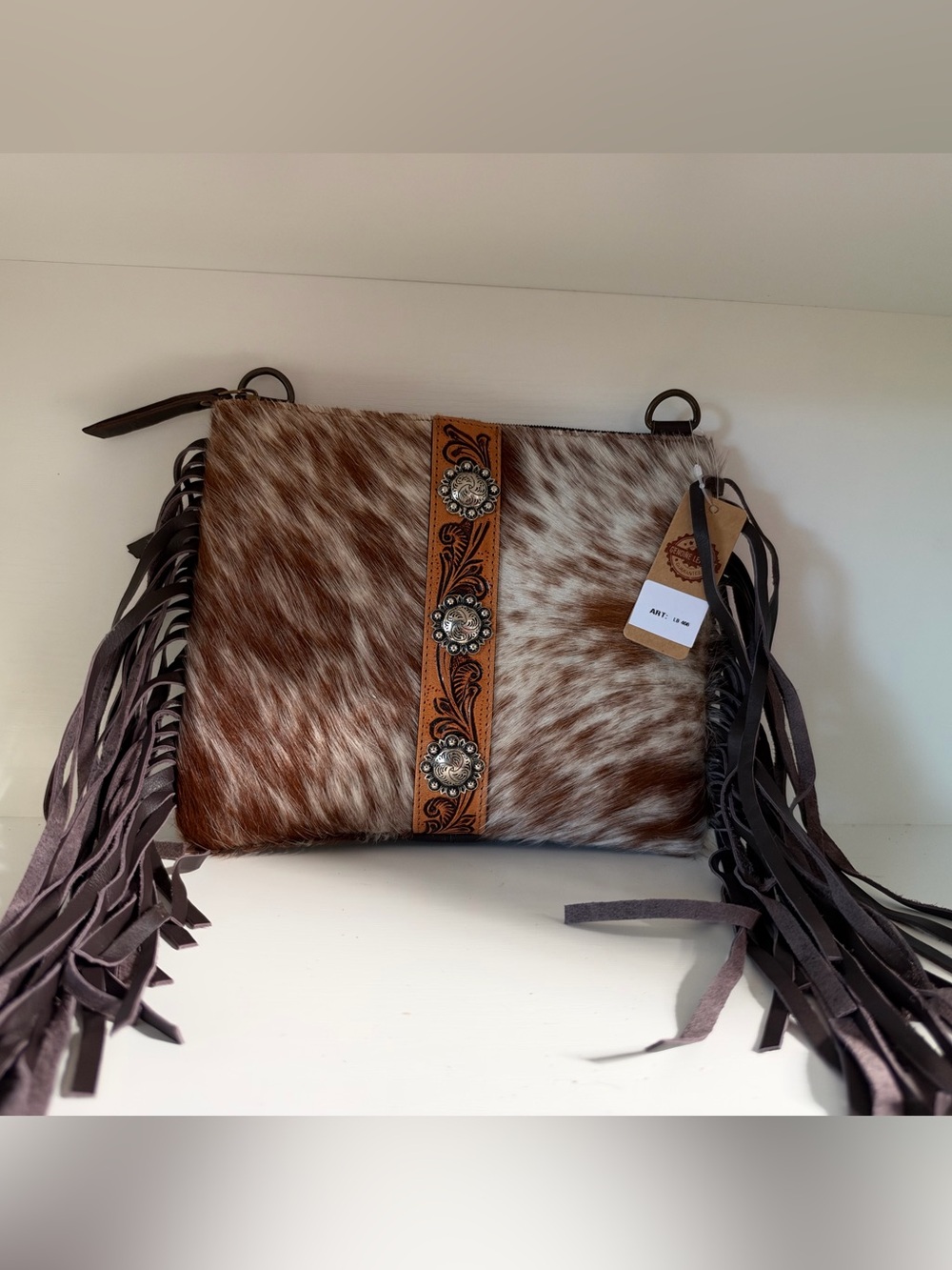 fringed brown and white cowhide crossbody bag